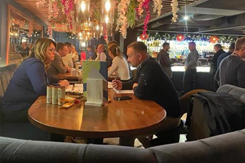 Two people networking over a dinner table