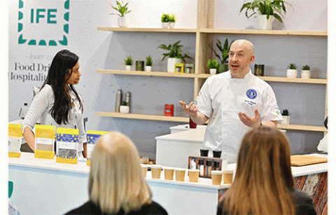 Man at IFE speaking about his products to an audience