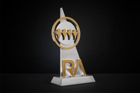A gold and silver trophy with the initials RA