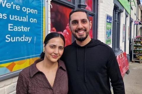 Two people stood outside a shop