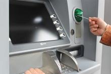 Close up of a person using a cash machine