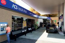 Exterior shot of a forecourt with a person using a cash machine