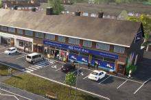 Exterior of a convenience store with four vehicles parked outside