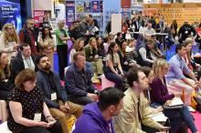 A crowd of people sitting and listening