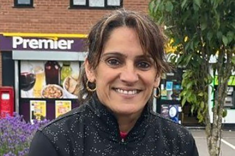 Woman smiling outside Premier store