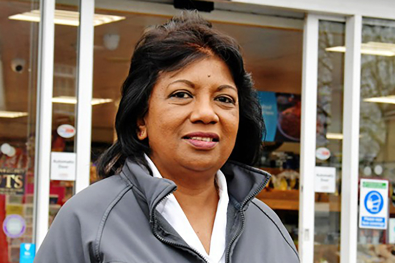 Woman smiling outside convenience store